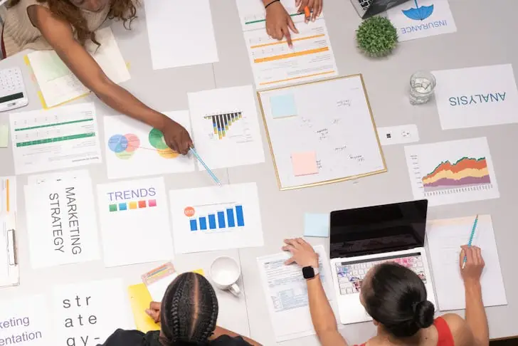 Why are tech companies laying off? Tech employees at work looking at trends.
