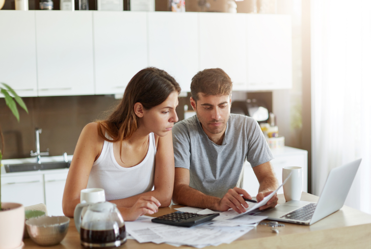 Family reviewing finances at home table